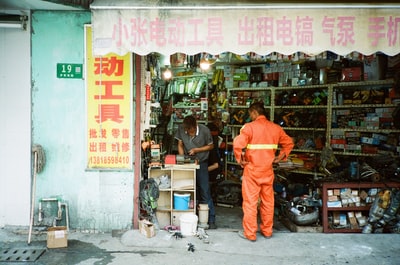 A man standing in front of another man in the shop
